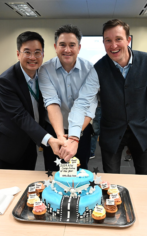 Let them eat cake: Tom Owen celebrates win with GM Cargo Services Frosti Lau (left) and GM Cargo Commercial George Edmunds (right)