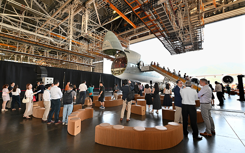Guests mingle around the hangar with the first new livery freighter as backdrop at the Cathay Cargo Rebranding event