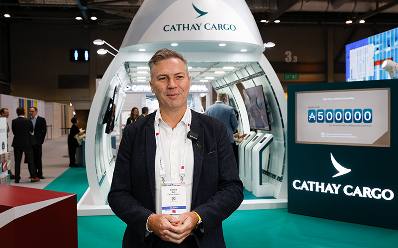 Cathay General Manager, Brand, Insights and Marketing Communications, Edward Bell in front of the Cathay cargo stand