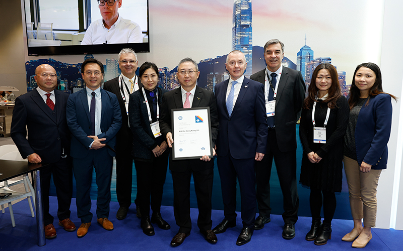 Clarence Tai, Chief Operating Officer at Air Hong Kong (centre) collects the membership certificate from IATA Director General Willie Walsh