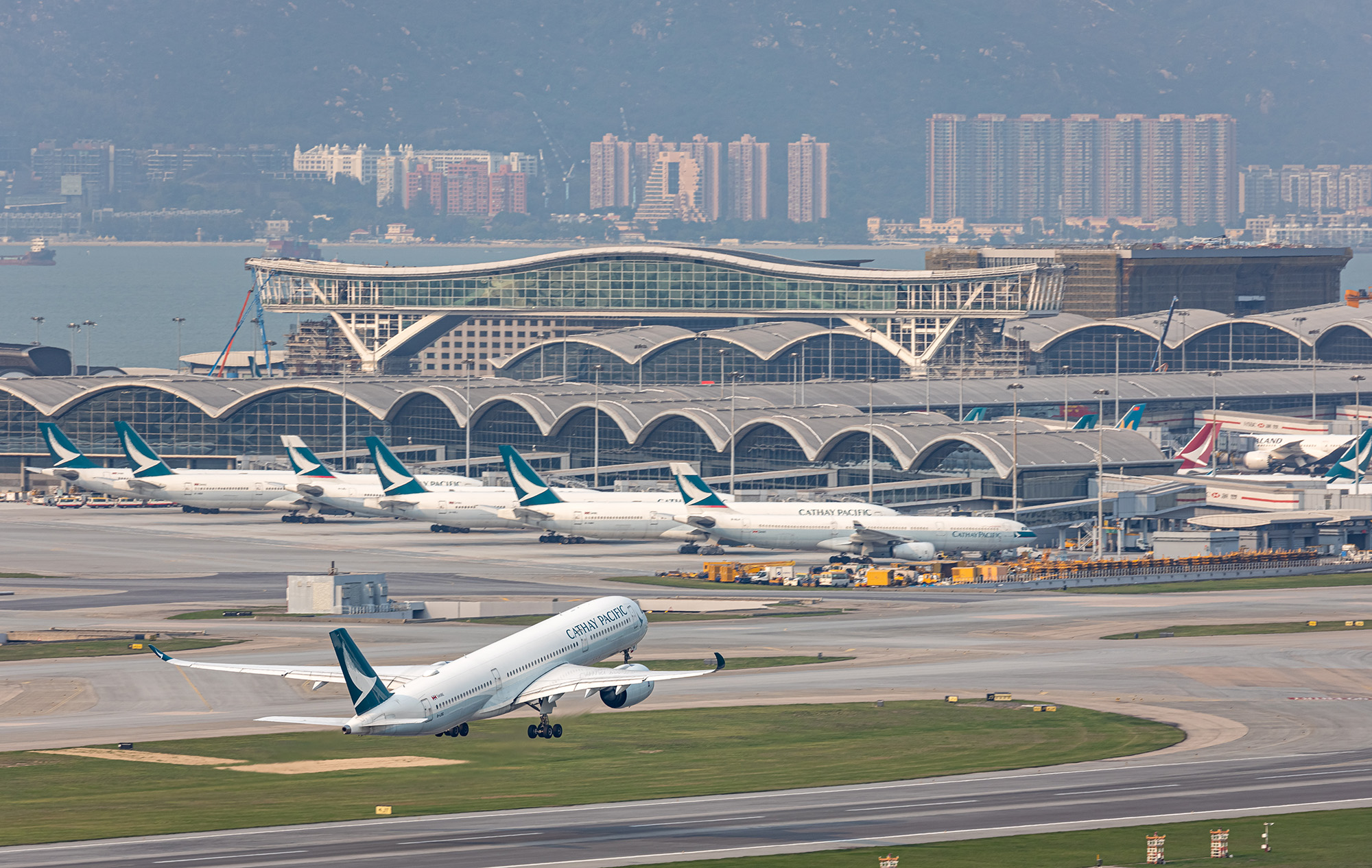 Cathay Pacific's Passenger airplane is running for take off at runway